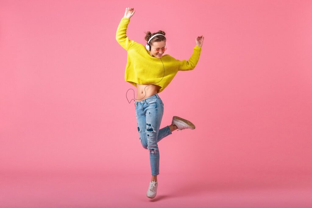 Dancer balancing on one leg in a joyful pose